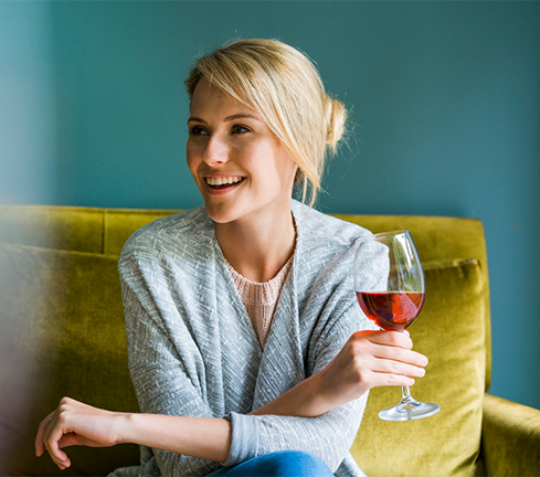 Image is of a woman drinking alcohol